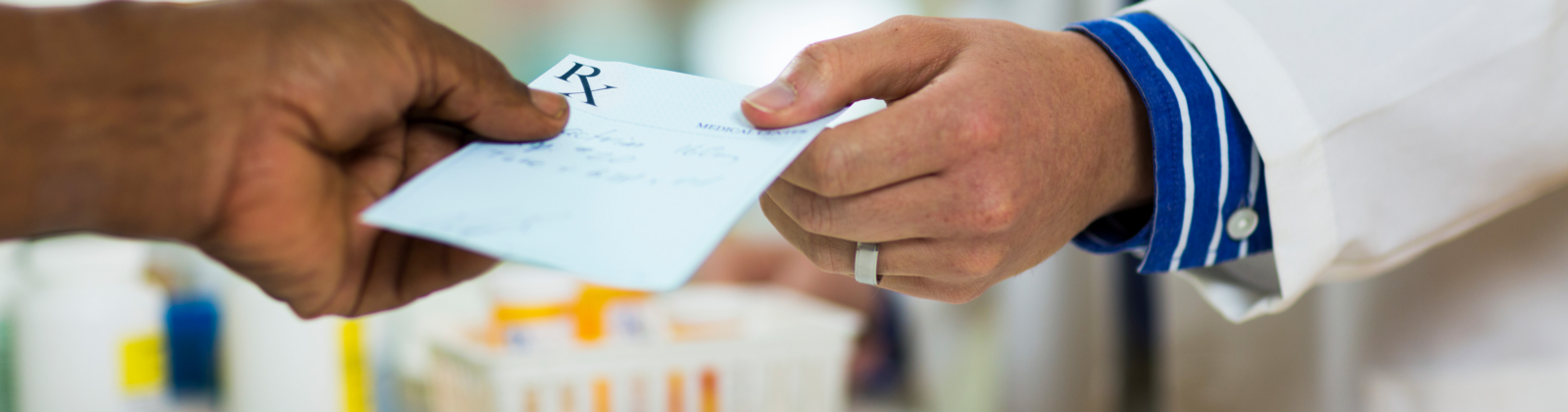 Two people receiving and giving a prescription.